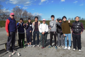 Keiichi, Jim and Barbara standing with a group of young players.